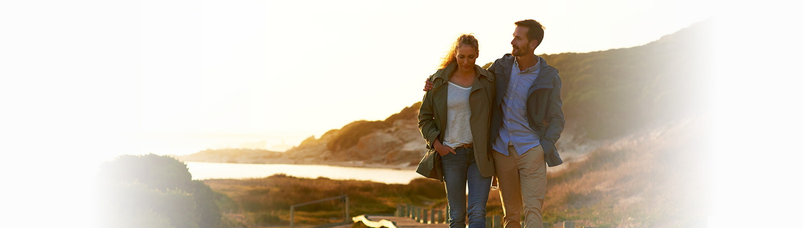 Happy couple out for a walk around the beach