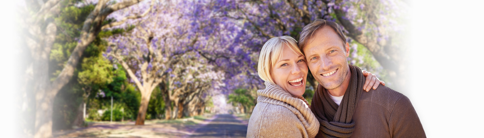 couple in front of jacaranda plant