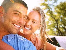 couple smiling outside